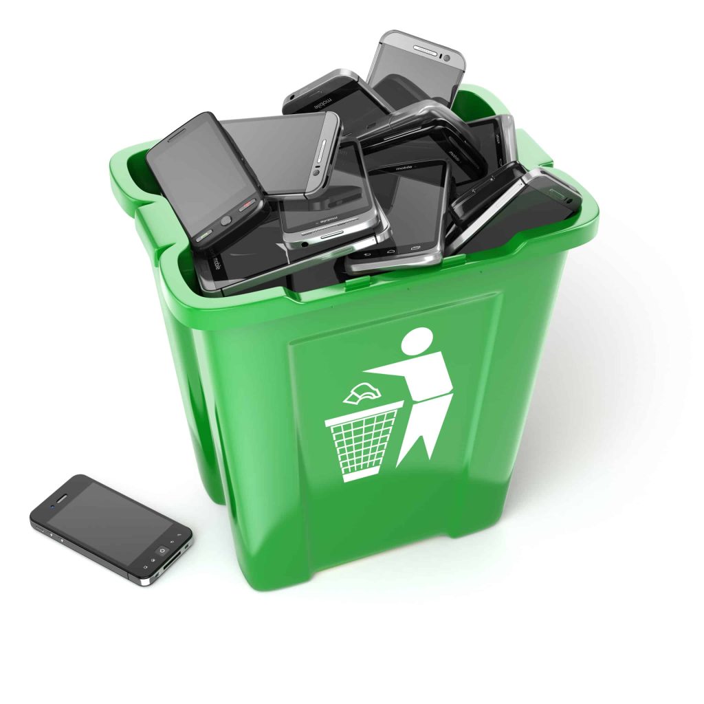 A green recycling bin filled with black smartphones is depicted, with one phone lying beside the bin. The bin features a white recycling symbol showing a figure discarding waste. This electronic recycling drop-off box perfectly represents efforts in Electronic Waste Atlanta GA initiatives.